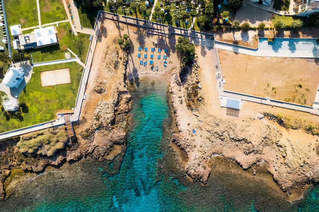pexels photo 10067349 10067349 A stunning aerial view of the Protaras coastline in Cyprus, showcasing vibrant blue waters and a rocky beach.