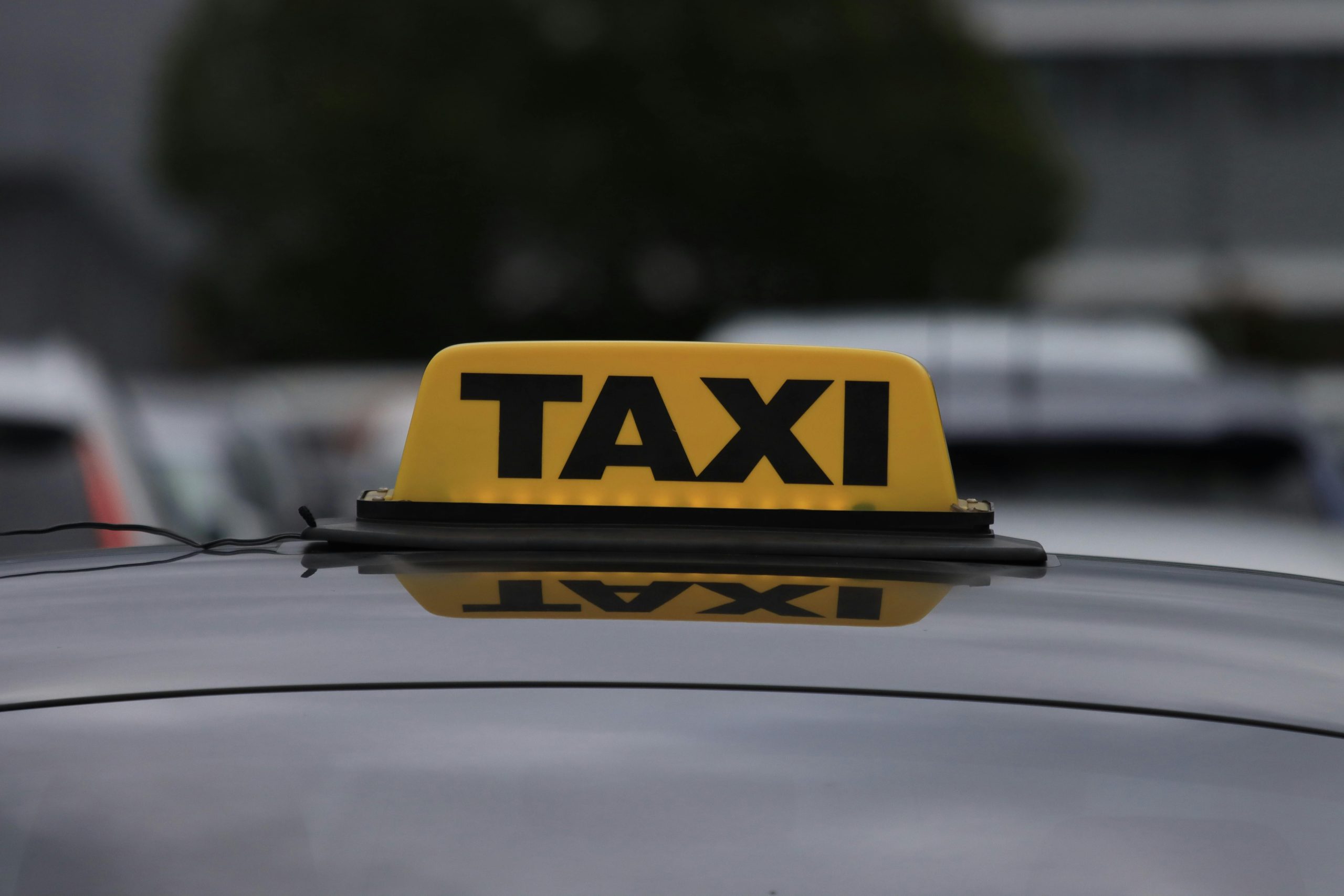 taxi sign on car roof in daylight