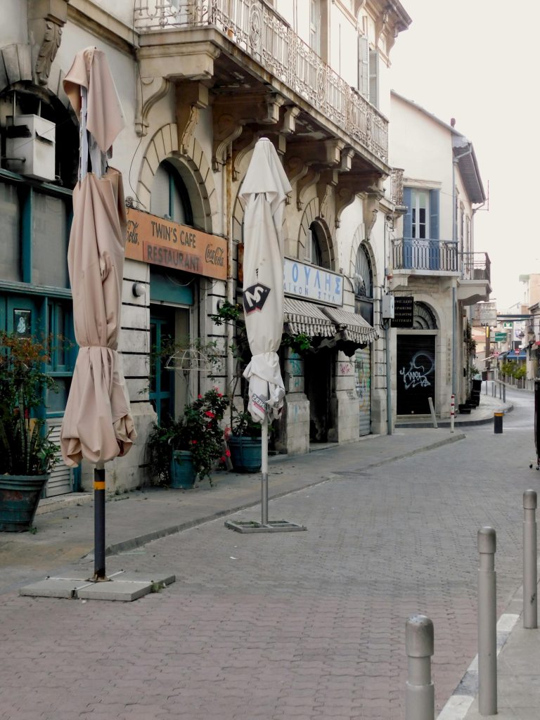 Explore a quaint historic street in Limassol with vintage architecture and charming cafes.