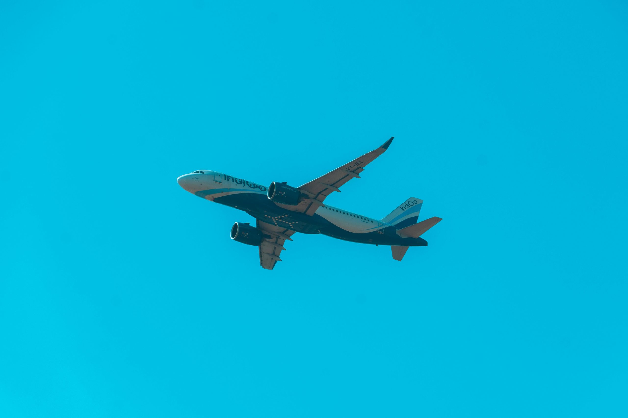 commercial airplane soaring through clear sky